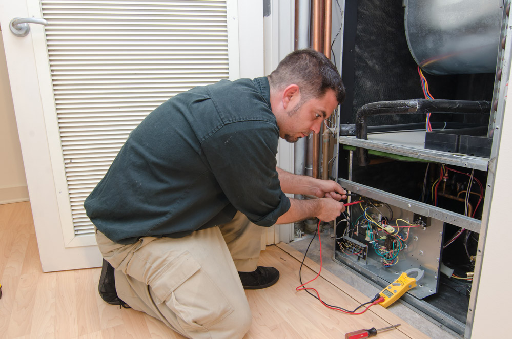 man installing hvac system